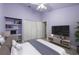 Modern bedroom featuring a built-in desk, a TV, and a walk-in closet at 4324 Auston Way, Palm Harbor, FL 34685