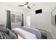 Bright bedroom with a window, ceiling fan, and closet for ample storage at 4324 Auston Way, Palm Harbor, FL 34685