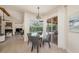 Bright dining area with a glass table, seating, and a view of the screened-in pool and patio at 4324 Auston Way, Palm Harbor, FL 34685