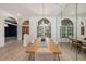 Dining room with large windows, and an oversized mirror across from the table at 4324 Auston Way, Palm Harbor, FL 34685