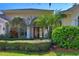 Charming front entrance with a covered porch and lush landscaping at 4324 Auston Way, Palm Harbor, FL 34685