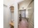 Hallway with coat rack nook leading to laundry area with washer and dryer; storage and shelving available at 4324 Auston Way, Palm Harbor, FL 34685