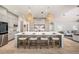 Large kitchen island with seating, designer pendant lights, and stainless steel appliances at 4324 Auston Way, Palm Harbor, FL 34685