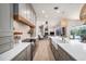Open kitchen featuring stainless appliances, range hood, farmhouse sink, and view to the pool and living area at 4324 Auston Way, Palm Harbor, FL 34685