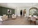Open-concept living area offers sightlines to the entry, dining room, and is accented by the sleek, light-colored flooring at 4324 Auston Way, Palm Harbor, FL 34685