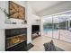 A cozy room features a fireplace and a view of the screened in pool area at 4324 Auston Way, Palm Harbor, FL 34685