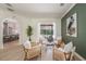 Bright living room with modern decor, wood floors, leading to a screened pool area at 4324 Auston Way, Palm Harbor, FL 34685