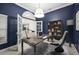 Office with a modern wood desk, stylish bookshelf, sleek chair, and bright natural light at 4324 Auston Way, Palm Harbor, FL 34685