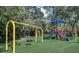 Community playground with colorful slides and swings, set in a verdant green space at 4324 Auston Way, Palm Harbor, FL 34685
