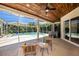 Outdoor space featuring a covered patio with a ceiling fan, wicker seating, and a view of the pool and hot tub at 4324 Auston Way, Palm Harbor, FL 34685