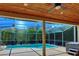 Enclosed pool area with a screened-in pool, spa, and wood ceiling, perfect for outdoor enjoyment at 4324 Auston Way, Palm Harbor, FL 34685