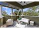 Beautiful outdoor terrace with comfortable seating, pergola, and stunning views of the foliage at 4907 Bayshore Blvd # 115, Tampa, FL 33611