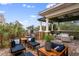 Elegant outdoor balcony featuring brick pavers, seating arrangements, and views of the surrounding greenery at 4907 Bayshore Blvd # 115, Tampa, FL 33611