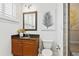 Well-lit bathroom featuring a granite vanity, toilet, shower with tiled walls, and a stylish mirror at 4907 Bayshore Blvd # 115, Tampa, FL 33611