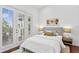 Comfortable bedroom featuring a queen bed with neutral decor, side tables, and access to an outdoor area at 4907 Bayshore Blvd # 115, Tampa, FL 33611