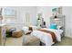 Bright bedroom featuring two twin beds, neutral walls, decor, and natural light from shuttered windows at 4907 Bayshore Blvd # 115, Tampa, FL 33611