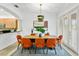 Dining room boasts bright light fixture, modern artwork, and comfortable orange seating at 4907 Bayshore Blvd # 115, Tampa, FL 33611