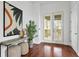 Stylish entryway with hardwood floors, decorative art, a console table, and double doors with plantation shutters at 4907 Bayshore Blvd # 115, Tampa, FL 33611