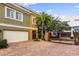 Mediterranean-style home with a paver driveway, a two-car garage, and gated entrance at 4907 Bayshore Blvd # 115, Tampa, FL 33611
