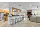 Open living room features travertine flooring, modern furnishings, and stylish kitchen bar at 4907 Bayshore Blvd # 115, Tampa, FL 33611