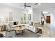 Comfortable living room with sectional sofa, natural light, and stylish staircase in background at 4907 Bayshore Blvd # 115, Tampa, FL 33611
