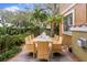 Private back patio featuring tropical landscaping, paved area, and an outdoor dining table at 4907 Bayshore Blvd # 115, Tampa, FL 33611