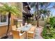 Exterior shot of patio area offers a tranquil outdoor dining experience amongst lush trees at 4907 Bayshore Blvd # 115, Tampa, FL 33611