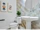 Stylish powder room with a pedestal sink, accent wall, and modern decor at 4907 Bayshore Blvd # 115, Tampa, FL 33611