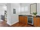 Charming wet bar featuring wood cabinets, granite counters, a beverage fridge, and a window with shutters at 4907 Bayshore Blvd # 115, Tampa, FL 33611