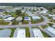 An aerial view of a single-story home in a well-manicured community with mature trees at 4920 Blanco Dr, Zephyrhills, FL 33541