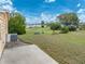 Grassy backyard with clothes line and space for outdoor activities at 4920 Blanco Dr, Zephyrhills, FL 33541