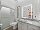 Well-lit bathroom with glass shower, stylish vanity, and modern mirror at 4920 Blanco Dr, Zephyrhills, FL 33541