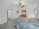 Bright bedroom with a large bed, ceiling fan, and dresser at 4920 Blanco Dr, Zephyrhills, FL 33541