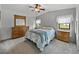 Cozy bedroom featuring a bed, dresser, and soft carpeting at 4920 Blanco Dr, Zephyrhills, FL 33541