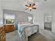 Serene bedroom with dual windows, neutral walls, and ceiling fan at 4920 Blanco Dr, Zephyrhills, FL 33541