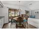 Elegant dining area with decorative lighting, stylish furnishings, and a sliding glass door at 4920 Blanco Dr, Zephyrhills, FL 33541