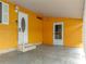 The entrance of a single-story home with a covered carport, steps, and decorative door at 4920 Blanco Dr, Zephyrhills, FL 33541