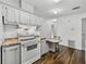 Bright kitchen featuring modern countertops, white cabinets, and an electric range at 4920 Blanco Dr, Zephyrhills, FL 33541
