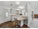 Bright kitchen featuring modern countertops, white cabinets, and a breakfast bar at 4920 Blanco Dr, Zephyrhills, FL 33541