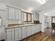 Well-lit kitchen with white cabinets, updated countertops, and a stainless-steel sink at 4920 Blanco Dr, Zephyrhills, FL 33541