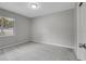 A standard bedroom featuring gray walls, plush carpeting, and a window for natural light at 5604 Cresthill Dr, Tampa, FL 33615