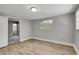 This freshly painted bedroom showcases modern flooring, a window for natural light, and a large entryway to another room at 5604 Cresthill Dr, Tampa, FL 33615