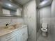 This bright bathroom features modern vanity and a glass-enclosed shower with marble-look tiling at 5751 94Th N Ave, Pinellas Park, FL 33782