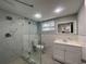 Modern bathroom with frameless glass shower, sleek fixtures, and white vanity offers plenty of space at 5751 94Th N Ave, Pinellas Park, FL 33782