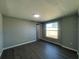 This neutral bedroom has gray laminate flooring, recessed lighting, and a large window that provides ample natural light at 5751 94Th N Ave, Pinellas Park, FL 33782