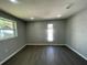 Neutral bedroom featuring gray laminate flooring, recessed lighting, and a large window offers ample natural light at 5751 94Th N Ave, Pinellas Park, FL 33782