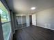 This bright bedroom offers gray laminate flooring, a mirrored closet, and a large window for plenty of natural light at 5751 94Th N Ave, Pinellas Park, FL 33782