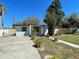 Inviting single-story home with a spacious driveway and beautifully landscaped front yard at 5751 94Th N Ave, Pinellas Park, FL 33782