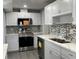 Stylish kitchen featuring stainless steel appliances, white cabinets, and modern backsplash at 5751 94Th N Ave, Pinellas Park, FL 33782