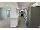 Modern kitchen with stainless steel appliances, an island, and gray wood flooring offers an eat in space at 5751 94Th N Ave, Pinellas Park, FL 33782